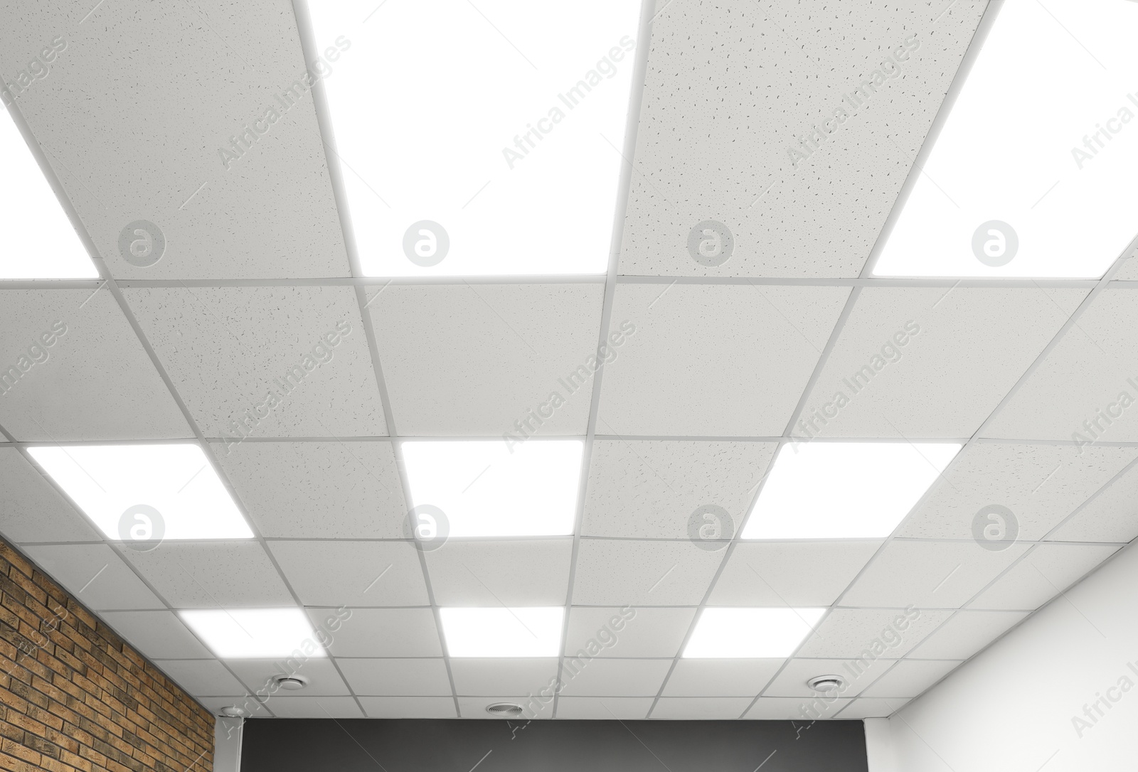 Photo of White ceiling with lighting in office room