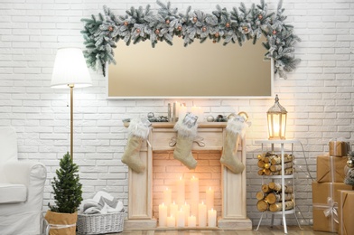 Room interior with mirror over fireplace decorated for Christmas