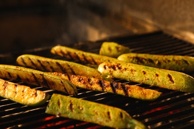 Photo of Cooking delicious fresh zucchini on grilling grate in oven