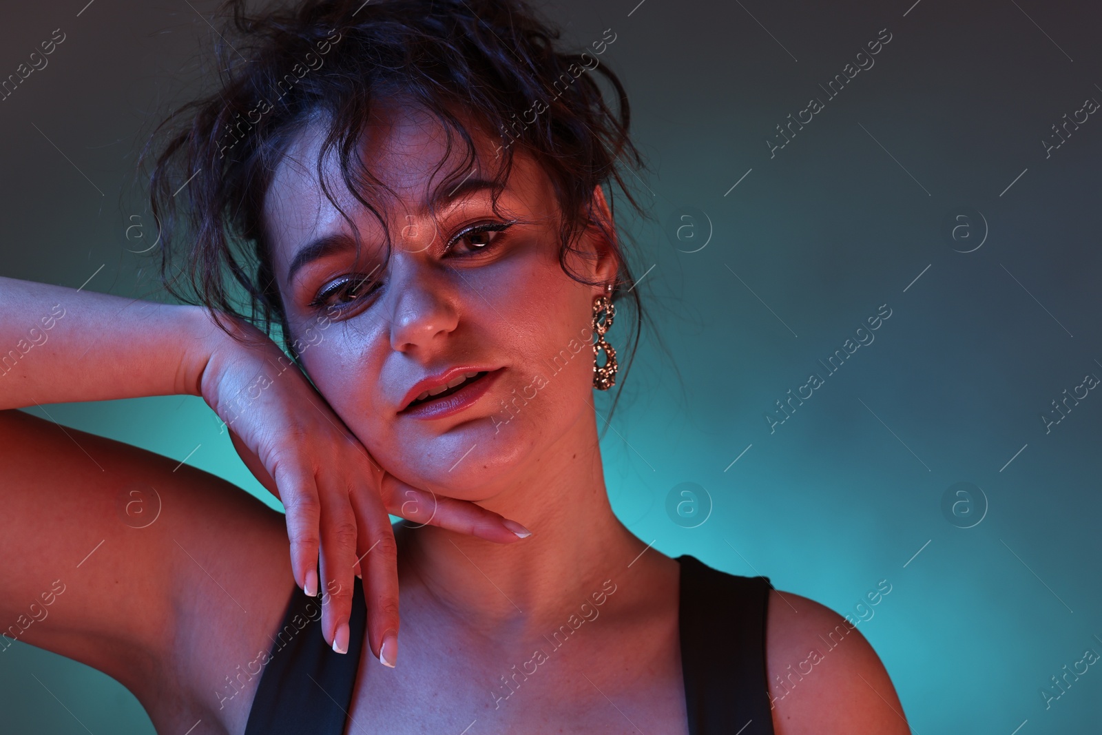 Photo of Portrait of beautiful woman on dark background with neon lights