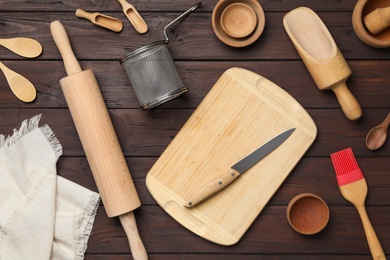 Photo of Set of modern cooking utensils on brown wooden table, flat lay