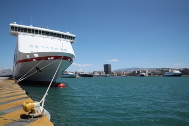 Photo of Modern ferry moored in sea port on sunny day