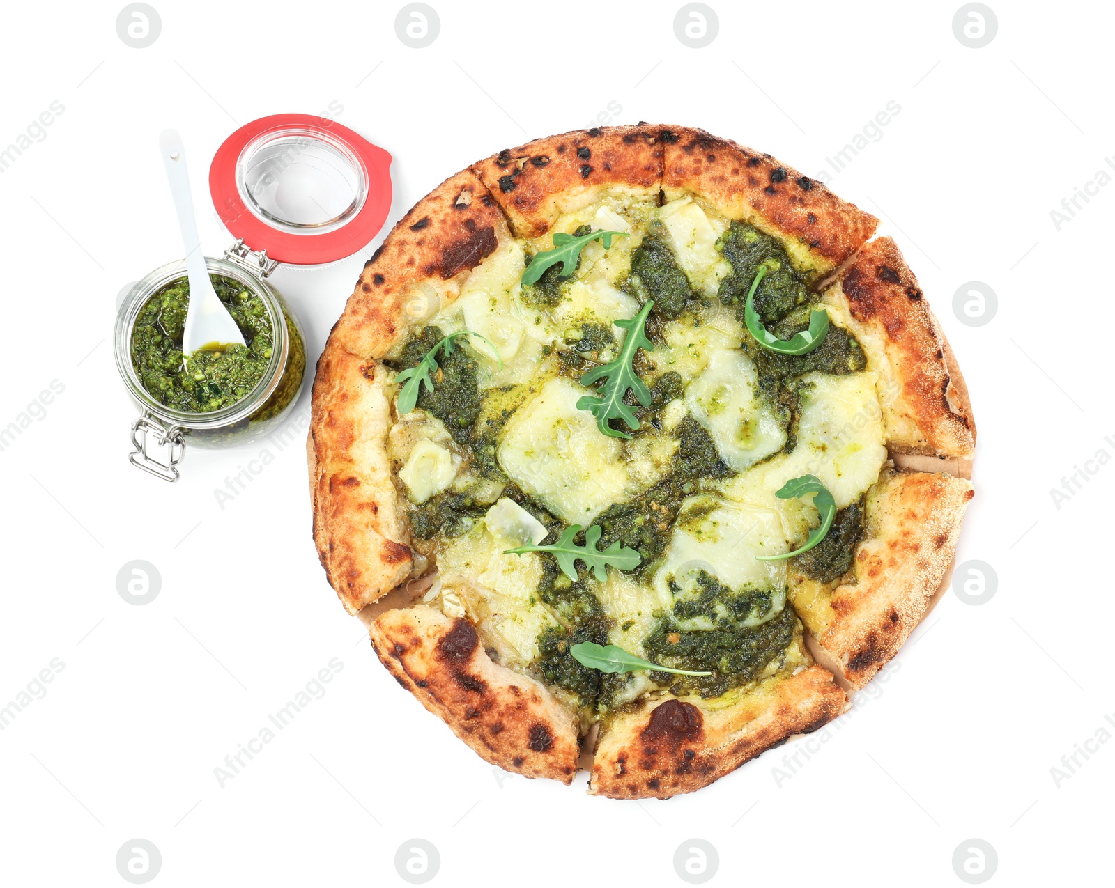 Photo of Delicious pizza with pesto, cheese and arugula near jar of sauce on white background, top view