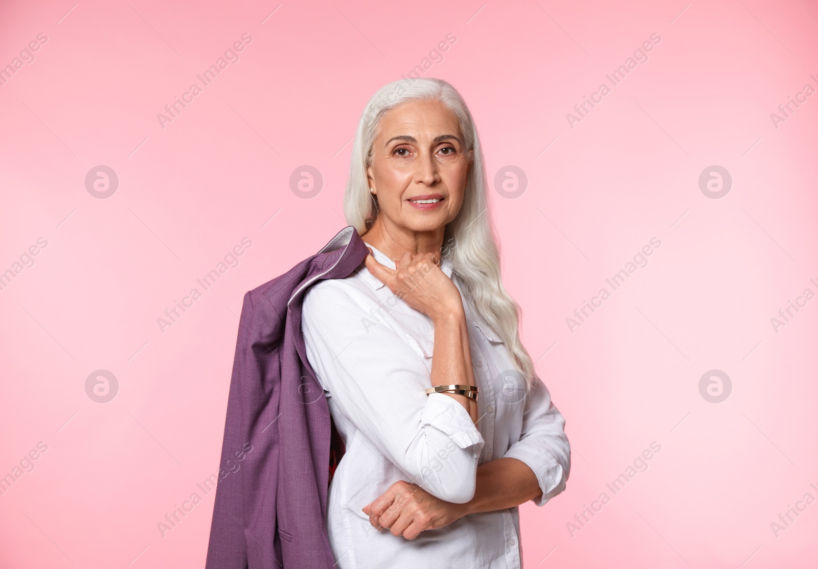 Photo of Portrait of beautiful mature woman on pink background