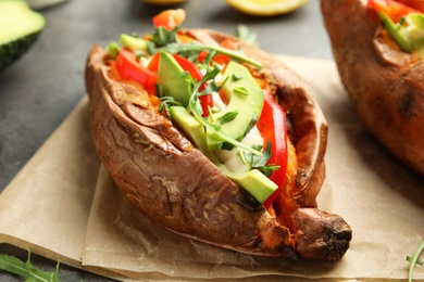 Stuffed sweet potato served on parchment, closeup