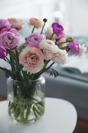 Image of Bouquet of beautiful ranunculuses on table in bedroom
