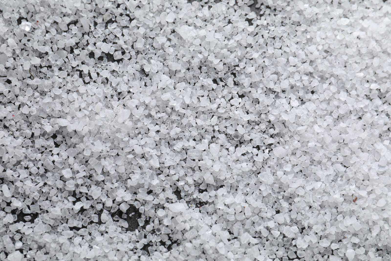 Photo of White natural salt as background, top view