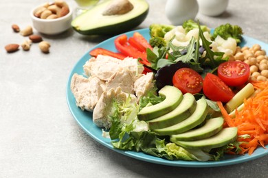 Photo of Balanced diet and healthy foods. Plate with different delicious products on grey table, closeup