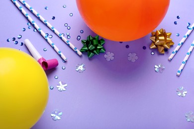 Photo of Different accessories for birthday party on violet background, flat lay. Space for text
