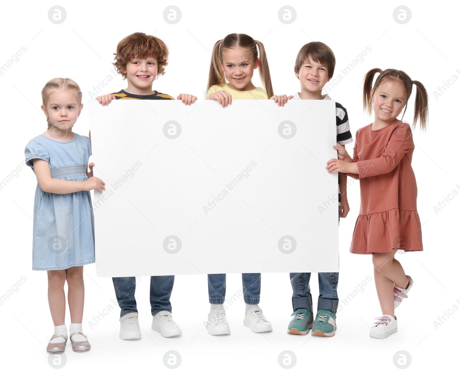 Photo of Group of children with blank poster on white background. Mockup for design