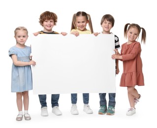 Photo of Group of children with blank poster on white background. Mockup for design