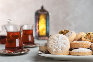 Traditional Islamic cookies and tea on table, space for text. Eid Mubarak