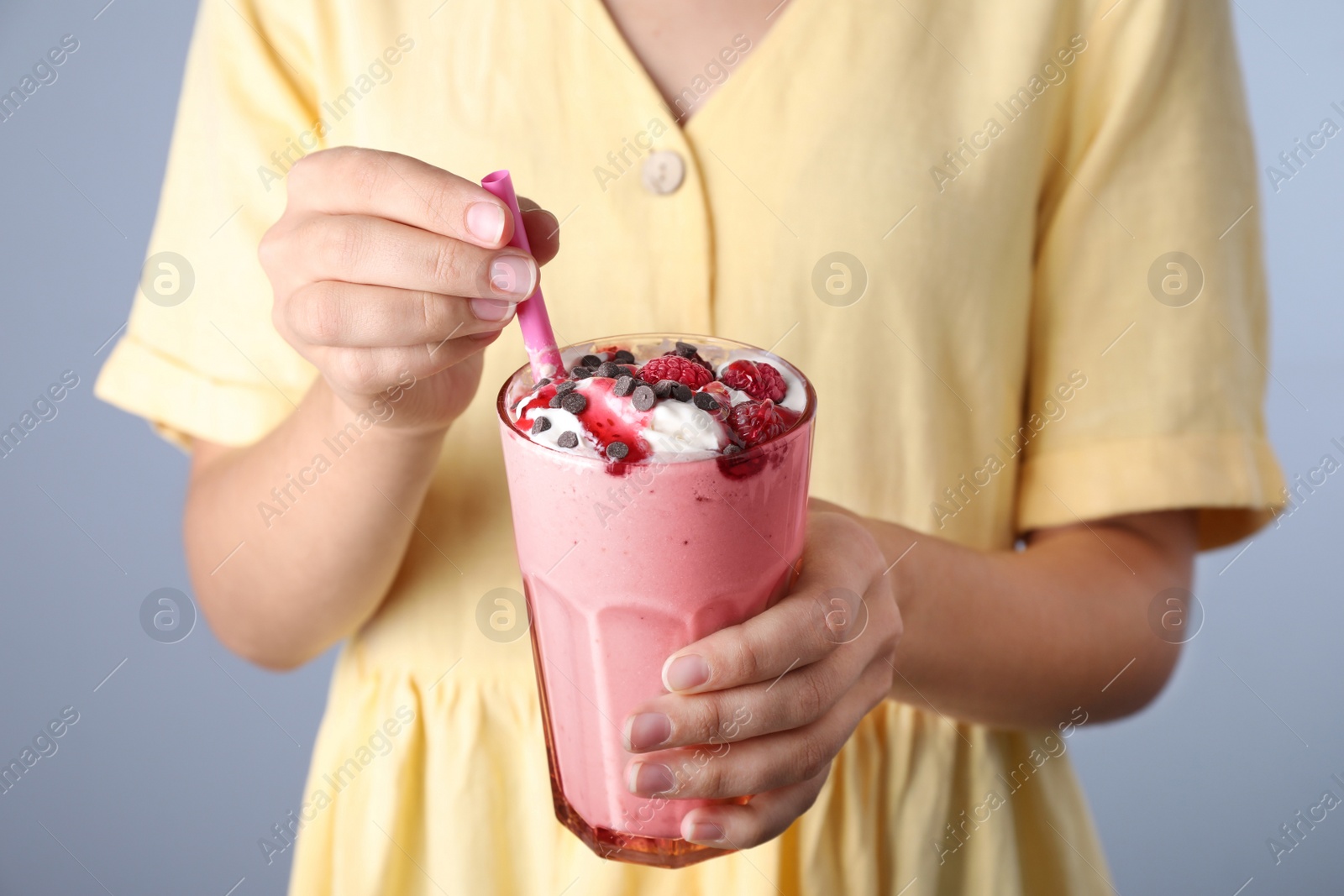 Photo of Woman with tasty milk shake on blue background, closeup