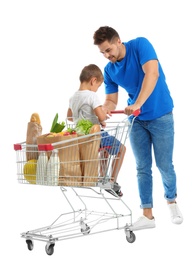 Photo of Father and son with full shopping cart on white background