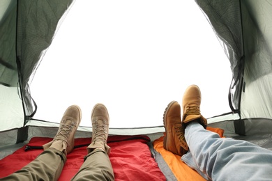 Photo of Closeup of couple in camping tent on white background, view from inside