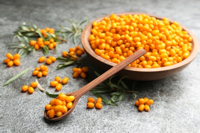 Photo of Fresh ripe sea buckthorn on grey table