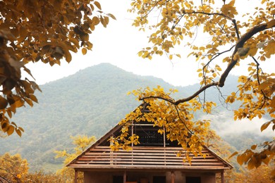 Photo of Beautiful wooden house with attic in mountains
