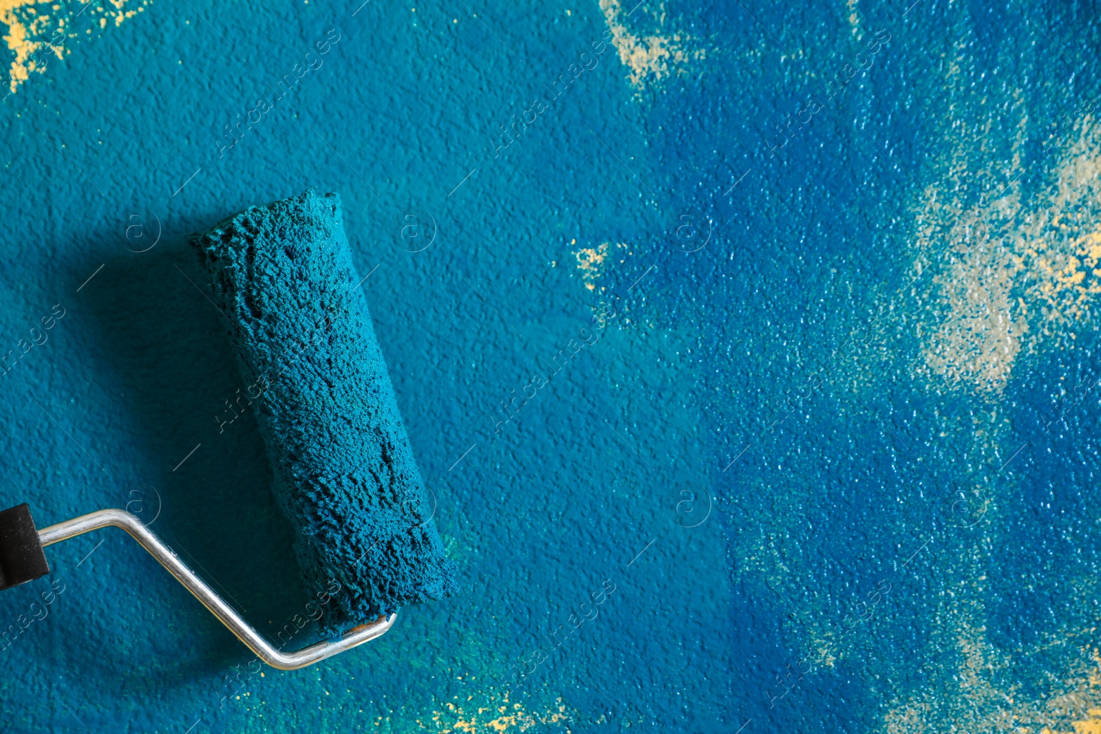 Photo of Painting wall with blue dye, closeup view