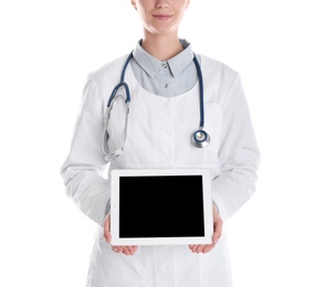 Photo of Female doctor holding modern tablet on white background, closeup. Space for design