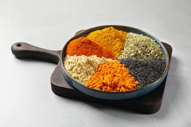 Photo of Plate with different spices on light grey table
