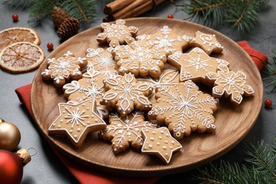 Tasty Christmas cookies and festive decor on grey table