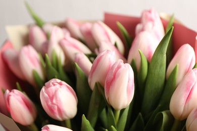 Photo of Beautiful bouquet of fresh pink tulips on light background, closeup