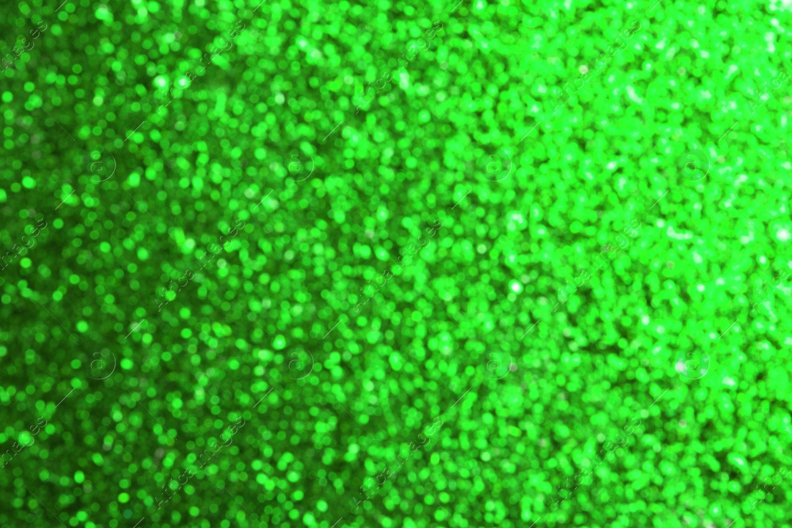 Image of St. Patrick day. Green glitter as background, blurred view. Bokeh effect