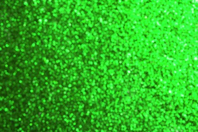 Image of St. Patrick day. Green glitter as background, blurred view. Bokeh effect