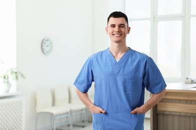 Photo of Smiling medical assistant in hospital. Space for text