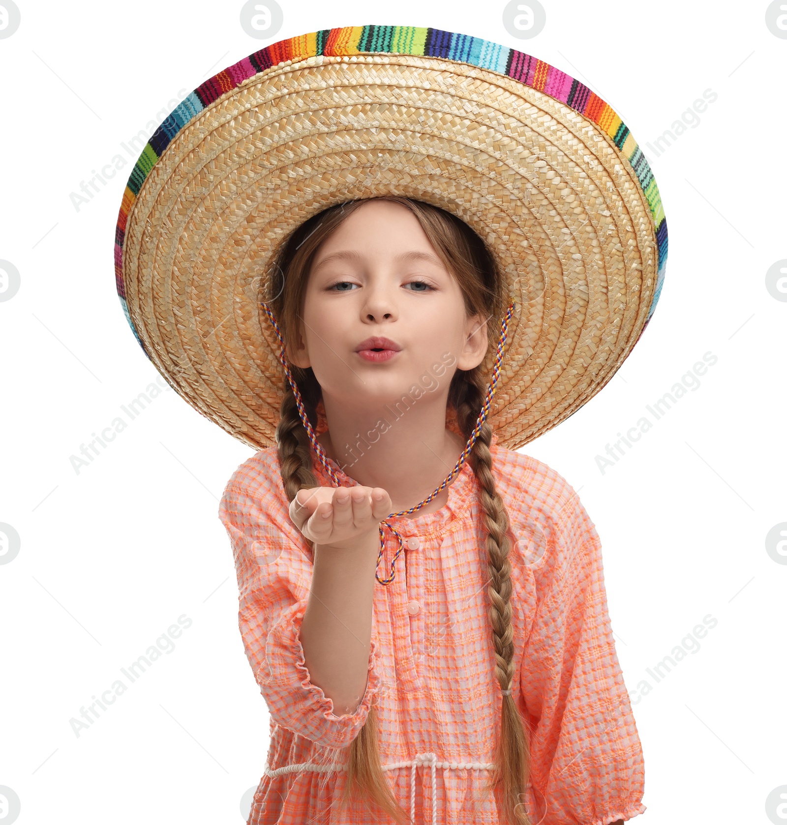 Photo of Cute girl in Mexican sombrero hat blowing kiss on white background