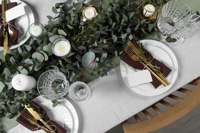 Luxury table setting with beautiful decor and blank cards. Festive dinner