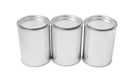 Photo of Many cans of paints on white background