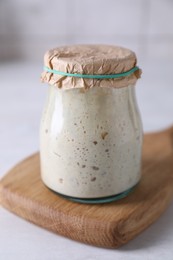 Sourdough starter in glass jar on light table