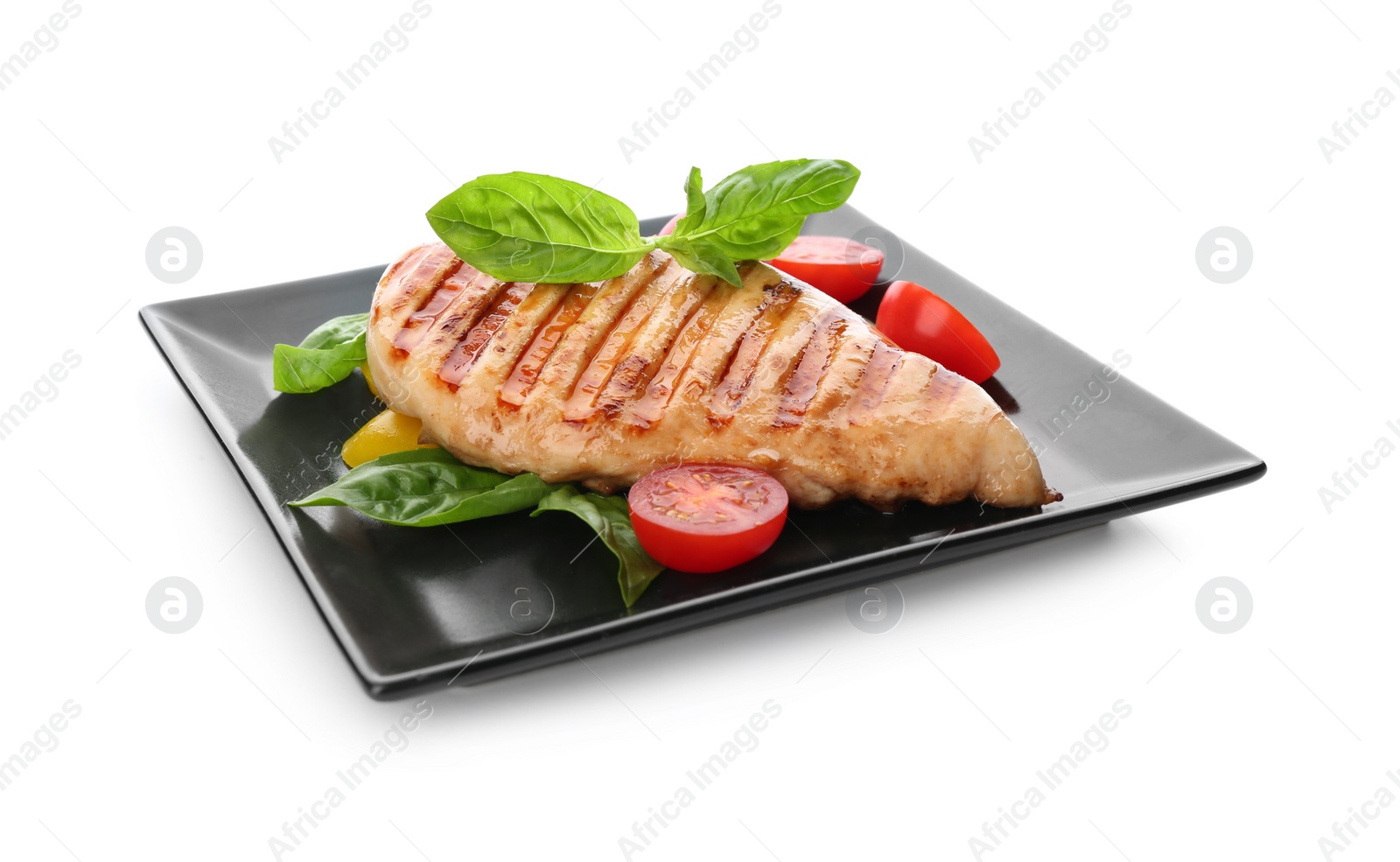 Photo of Tasty grilled chicken fillet with green basil and vegetables isolated on white