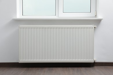 Photo of Modern radiator at home. Central heating system