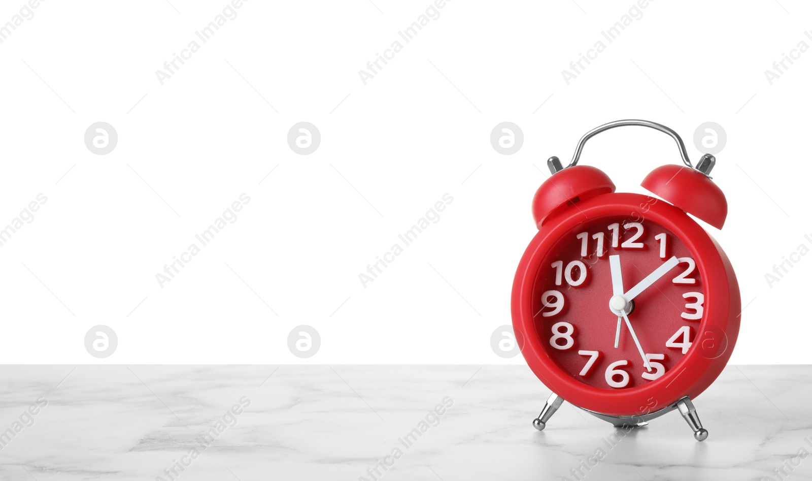 Photo of Alarm clock on table against white background. Time concept