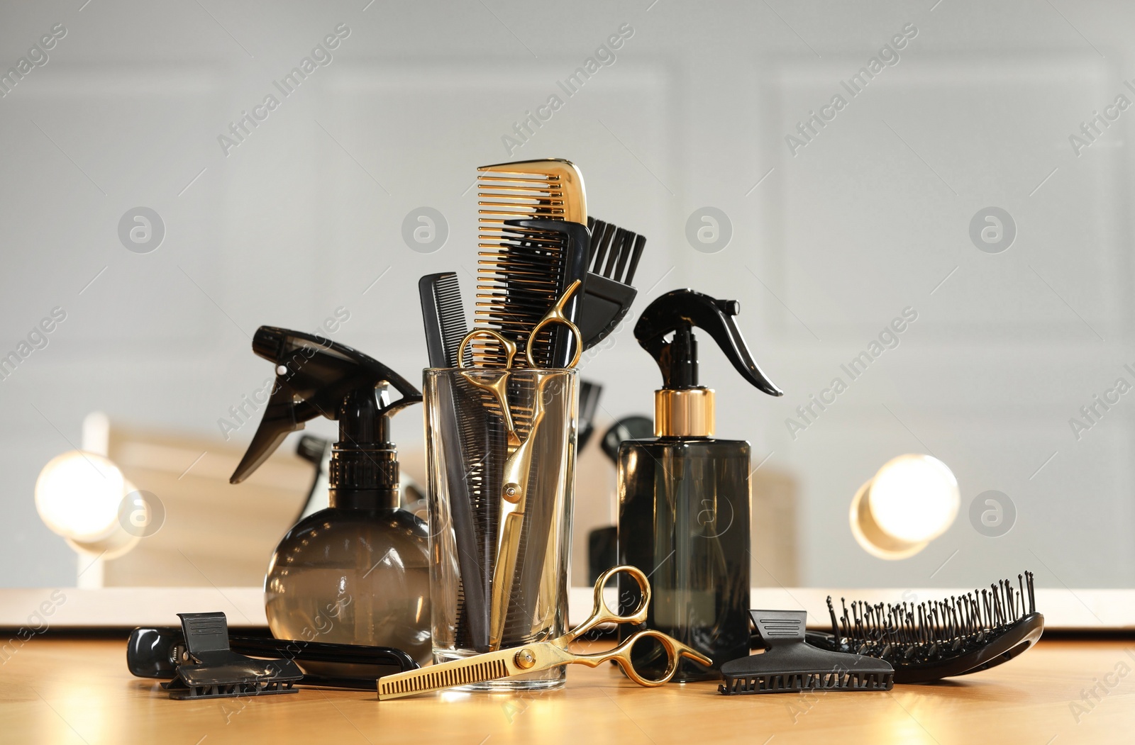 Photo of Set of hairdresser tools on table in salon