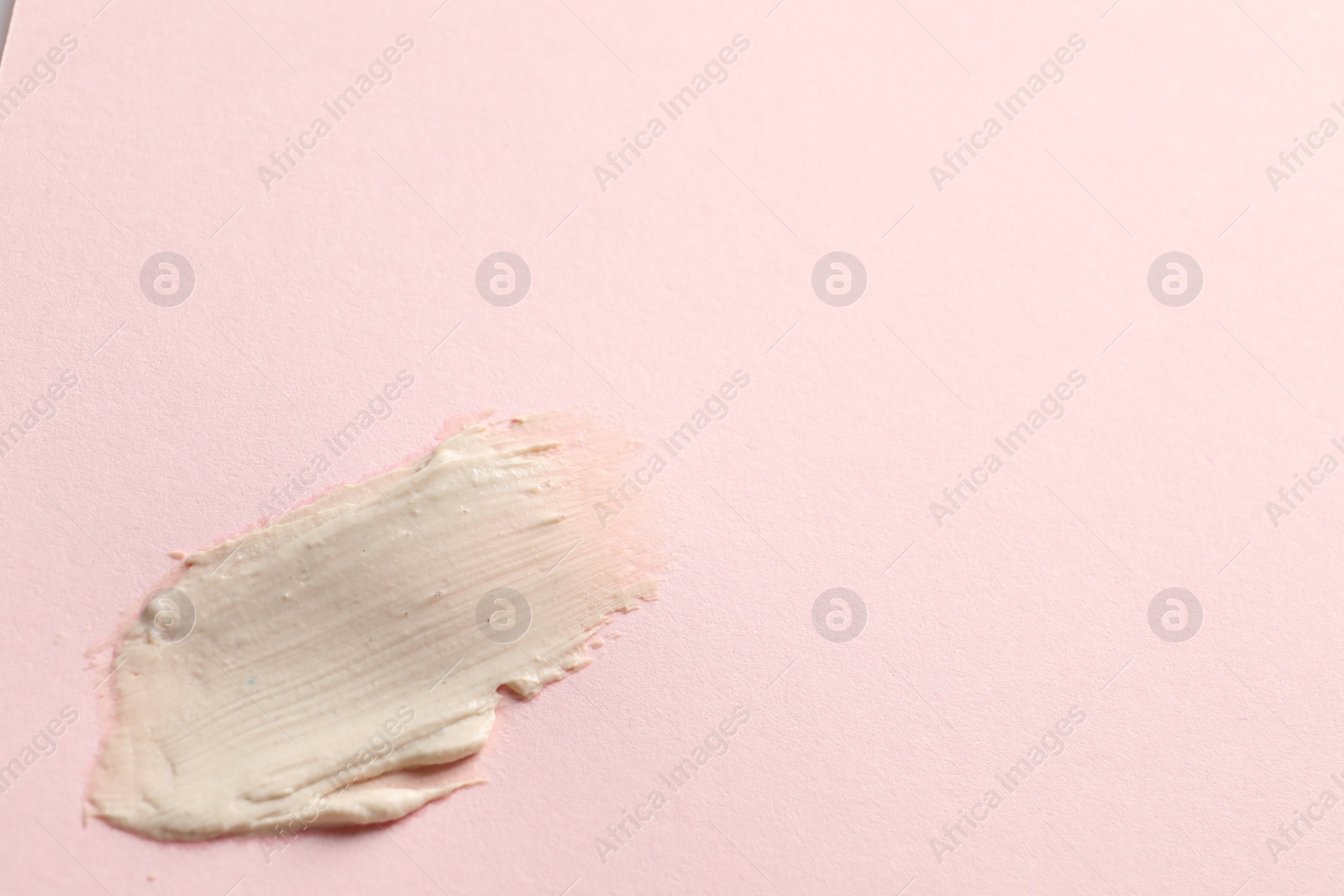 Photo of Sample of face mask on pink background, top view. Space for text