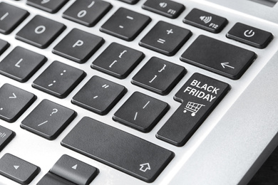 Laptop keyboard with Black Friday button, closeup. Online shopping 