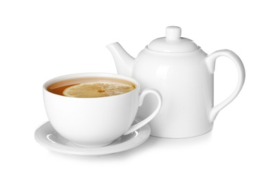 Teapot and cup of tea with lemon on white background