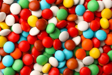 Photo of Many small colorful candies as background, top view