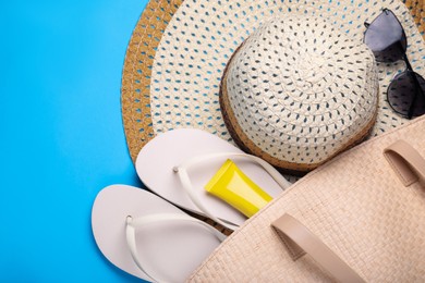 Photo of Flat lay composition with beach accessories on light blue background, space for text