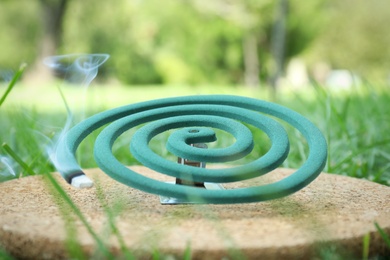 Photo of Smouldering insect repellent coil on board outdoors