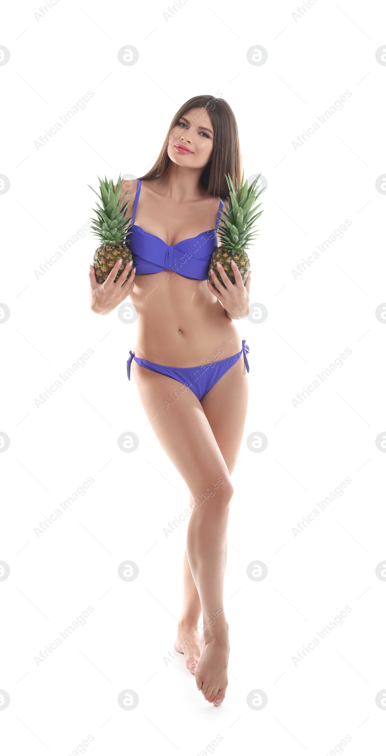 Photo of Sexy young woman in bikini with pineapples on white background