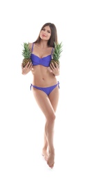 Photo of Sexy young woman in bikini with pineapples on white background