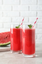 Photo of Tasty summer watermelon drink in glasses on table