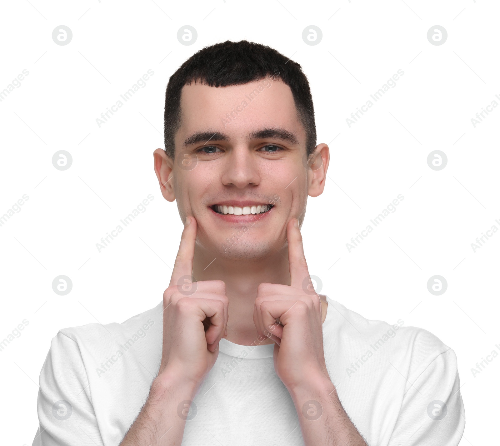 Photo of Handsome young man showing his clean teeth on white background