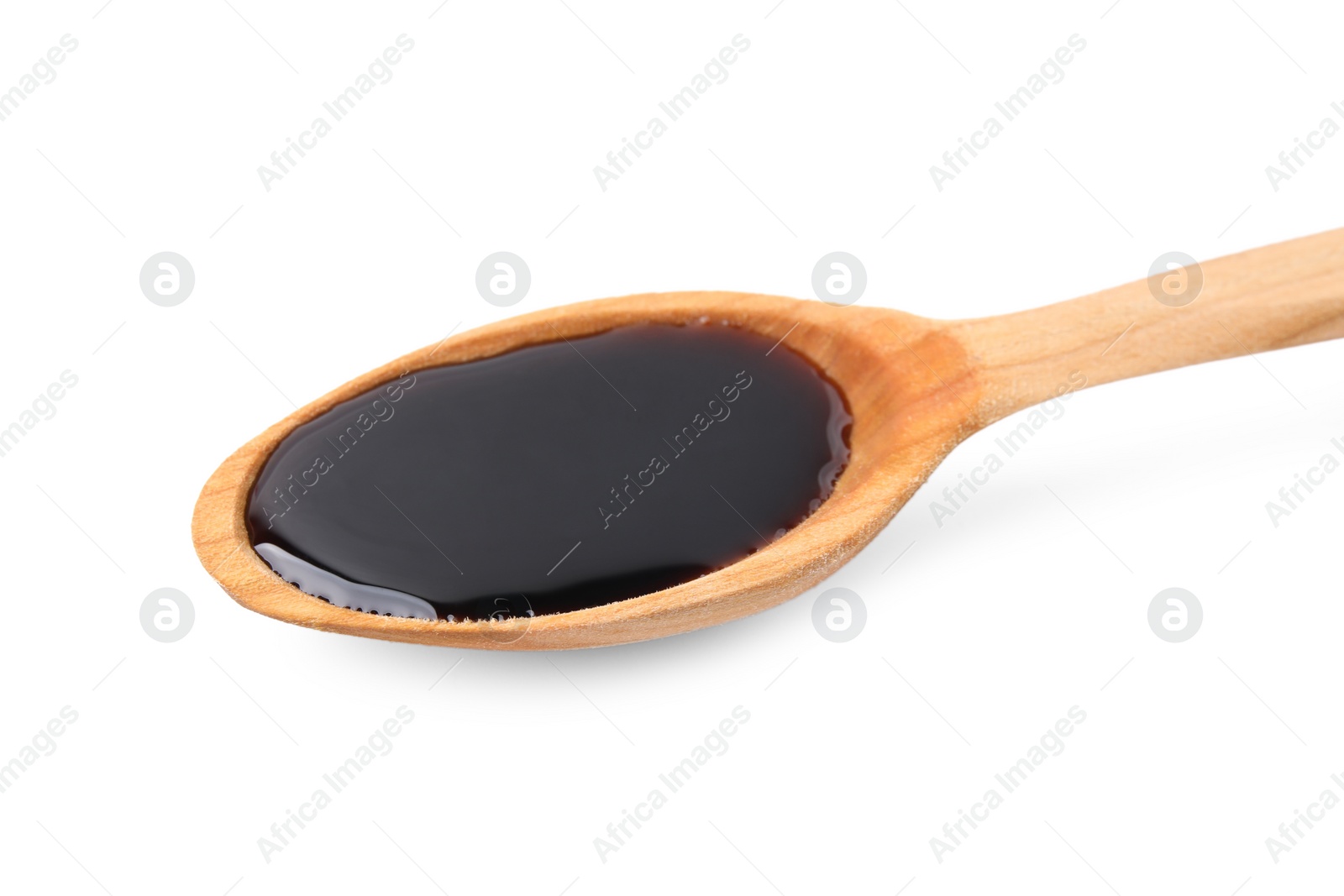 Photo of Wooden spoon with delicious caramel syrup isolated on white