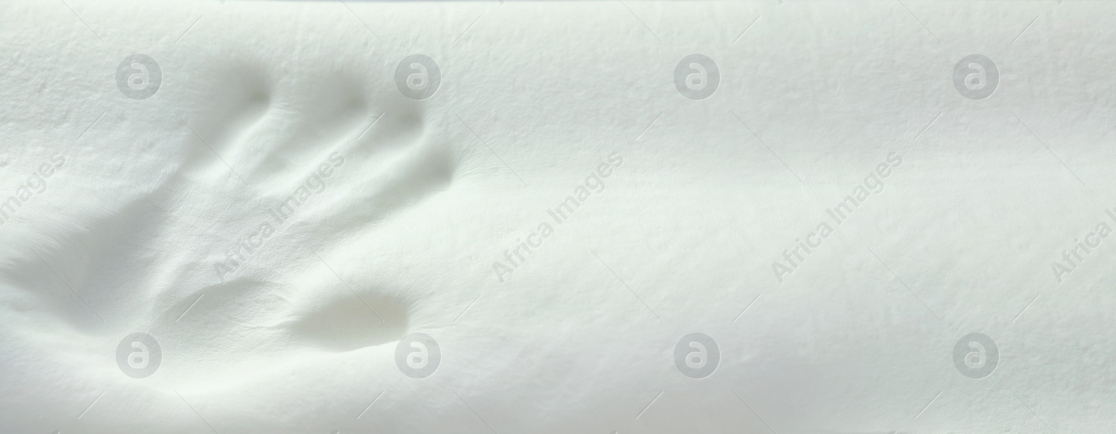 Image of Handprint on white memory foam pillow, closeup. Banner design with space for text