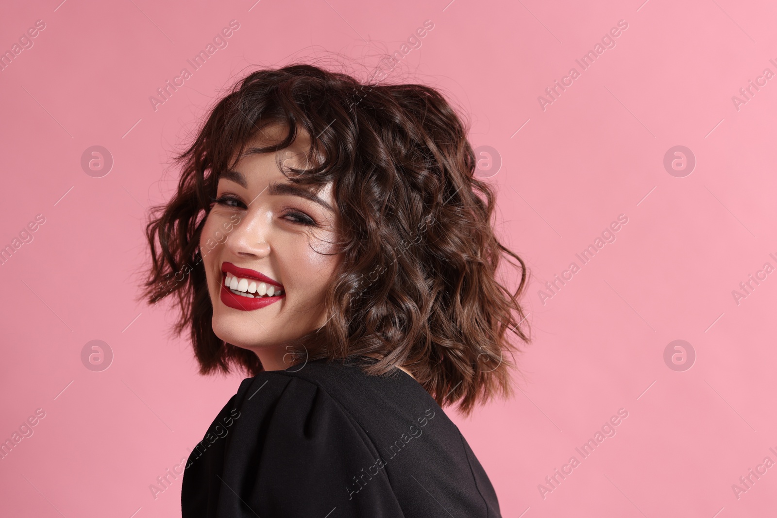 Photo of Portrait of beautiful young woman with wavy hairstyle on pink background. Space for text